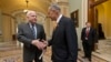 Sen. John McCain, left, and Sen. Charles Schumer, right, two of the authors of the immigration reform bill crafted by the Senate's bipartisan "Gang of Eight," shakes hands on Capitol Hill, June 27, 2013, prior to the final vote.
