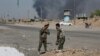 Iraqi security forces and Popular Mobilization Forces patrol in Tuz Khormato, which was evacuated by Kurdish security forces, 130 miles (210 kilometers) north of Baghdad, Iraq, Oct. 16, 2017. 