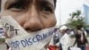 A Cambodian protester tapes his mouth shut in protest against discrimination of the Lesbian, Gay, Bisexual and Transgender (LGBT), in front of National Assembly, in Phnom Penh, file photo. 