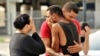 Friends and family members of Pulse victims embrace outside Orlando Police Headquarters, June 12, 2016.