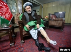 FILE - Ahmad Ishchi, who is alleged to have been beaten and detained by Afghanistan's first vice president, Abdul Rashid Dostum, displays an injury on his leg during an interview at his home in Kabul, Afghanistan, Dec. 13, 2016.