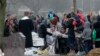 The mother of Maria Francesca, who died of sudden infant death syndrome, cries in front of the coffin of her baby during the funeral in Wissous, outside Paris, France, Monday, Jan. 5, 2015. Wissous offered a gravesite for the baby after the mayor of Champ