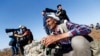 Turkish Kurds watch the Syrian town of Kobani from a hill near the Mursitpinar border crossing, in Suruc, Oct. 24, 2014. 