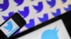 (FILES) In this file photo taken on May 2, 2019 logos of US social network Twitter are displayed on the screen of smartphones, in Nantes, western France. - Twitter staff across the world were asked to work from home starting on March 2, 2020 in an…