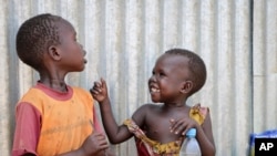 FILE - Children play outside a community center at an internally displaced person's camp, in the capital Juba, South Sudan, April 2, 2019.