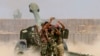 Fighters take a selfie while firing artillery against Islamic State militants in Fallujah, Iraq on Sunday, May 29, 2016.