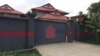 The refugees have all been settled in a large guarded compound with high walls in what appears to be new, high-quality housing.