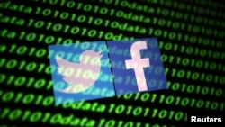 FILE - The Twitter and Facebook logo along with binary cyber codes are seen in this illustration, Nov. 26, 2019. 