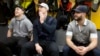 FILE - Boston Bruins players, from left, Frank Vatrano, Noel Acciari and Tyler Randell sit in the locker room during an end of season media availability at TD Garden in Boston.