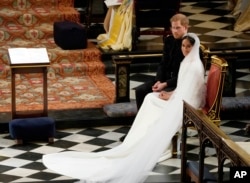 Britain's Prince Harry and Meghan Markle during their wedding at St. George's Chapel in Windsor Castle in Windsor, near London, England, Saturday, May 19, 2018.
