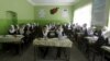 FILE - Class 11 Afghan girl students attend a class at Zarghona high school in Kabul, Afghanistan, Aug. 15, 2015. 