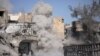 Smoke rises after a landmine exploded as fighters of Syrian Democratic Forces are clearing roads after the liberation of Raqqa, Syria, Oct. 18, 2017. 