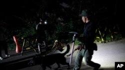 South Korean police officers with dogs leave to search for missing Seoul Mayor Park Won-soon in Seoul, South Korea, Thursday, July 9, 2020. (AP Photo/Lee Jin-man)
