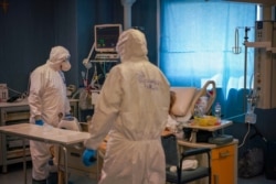 Medical staff tends to a patient in the ICU unit of Rome's San Filippo Neri Hospital's Covid department, in Rome, April 9, 2020.