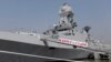 FILE - Indian Navy personnel board the newly built INS Kochi, a guided missile destroyer, during a media tour at the naval dockyard in Mumbai, Sept. 28, 2015. 