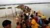 Rohingya refugees wait for boat to cross a canal after crossing the border through the Naf river in Teknaf, Bangladesh, Sept. 7, 2017.