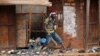 FILE - Anti-Balaka Christan youth loot the Muslim market in the PK13 district of Bangui, Central African Republic, Jan. 22, 2014. 