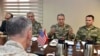 FILE - The U.S. chairman of the Joint Chiefs of Staff, Gen. Joseph Dunford, (back to camera), and Turkey's Chief of Staff Gen. Hulusi Akar (2nd R) talk during a meeting in Incirlik Airbase in Adana, Turkey, Feb. 17, 2017, about the need to fight terror groups in Syria and Iraq.