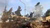 FILE - А volunteer fighter with Syrian government forces sits atop a tank in the province of Raqqa, Syria, Feb. 17, 2016. Iranian troops have backed the Assad regime, and have faced heavy losses in the process.