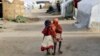 Ami and Ashbu, both three-years-old, walk arm in arm in the Zafaye refugee camp, some 15 kms (10 miles) from downtown N'djamena, Chad, March 11, 2015
