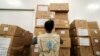 FILE - A World Food Program worker arranges relief packages for humanitarian aid for Africa to combat the outbreak of the coronavirus disease, at the Bole International Airport in Addis Ababa, Ethiopia, April 14, 2020. 