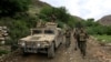 FILE - Afghan Special Forces patrol at the site where a MOAB, or ''mother of all bombs," was dropped on the Achin district of the eastern province of Nangarhar, Afghanistan, April 23, 2017. 
