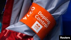 FILE - A doping control official attends the women's semifinal ice hockey game played by Canada vs the Olympic Athletes from Russia, Feb. 19, 2018, at the Pyeongchang 2018 Winter Olympics in Gangneung, South Korea.