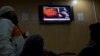 FILE - People watch a news report on TV about the leader of Pakistani Taliban leader Fazlullah Khurasani, at a coffee shop in Islamabad, Pakistan, Nov. 7, 2013.