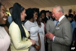 Britain's Prince Charles meets members of the The Kingdom Choir, who performed during the Royal Wedding of Prince Harry and Meghan Markle, during a party at Buckingham Palace, May 22, 2018. The event marked the 70th birthday of Prince Charles.