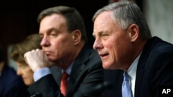 FILE - Senate Intelligence Committee Chairman Richard Burr, R-N.C., right, speaks next to Vice Chairman Mark Warner, D-Va., during a hearing on Russian election activity and technology, on Capitol Hill in Washington, Nov. 1, 2017.