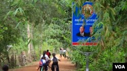 រូបឯកសារ៖ ក្មេងៗ​សិស្សសាលា​ជិះកង់​កាត់​ស្លាកសញ្ញា​នៃ​មេដឹកនាំគណបក្ស​ប្រជាជនកម្ពុជា ដែល​មាន​រូប​លោកនាយករដ្ឋមន្រ្តី ហ៊ុន សែន ជា​ប្រធានគណបក្ស និង​ លោក ហេង សំរិន ប្រធាន​រដ្ឋសភា នៅ​តាម​ផ្លូវ​ក្នុង​ភូមិ​បន្ទាយមាស ឃុំ​តាជេស ស្រុក​កំពង់ត្រឡាច ខេត្តកំពង់ឆ្នាំង។ រូបថត​ថ្ងៃ​ពុធ ទី​៨ ខែ​វិច្ឆិកា ឆ្នាំ​២០១៧។ (ស៊ុន ណារិន/VOA)