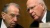 Chairman of the Senate Judiciary Committee, Senator Patrick Leahy (D-VT) (R) and Senator Chuck Grassley (R-IA) (L), confer before listening to NSA Director General Keith Alexander (not pictured) in Washington, Dec. 11, 2013.