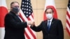 Japan's Prime Minister Yoshihide Suga, right, and U.S. Secretary of State Mike Pompeo, left, greet prior to their meeting at the prime minister's office in Tokyo, Tuesday, Oct. 6, 2020. (Charly Triballeau/Pool Photo via AP)