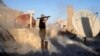 An American volunteer fighter of Syrian Democratic Forces fires an RPG during a battle with Islamic State militants in Raqqa, Syria, Oct. 6, 2017. An American surrendered to US-backed fighters in Syria in mid-September and is being held as an unlawful com