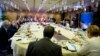 German Chancellor Angela Merkel, right, joins other EU leaders for a breakfast meeting during an EU summit in Brussels, Oct. 20, 2017. 