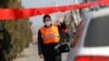 A village committee member stops a car for checking as he guards the entrance of a community amid China's battle against a new coronavirus, in Tianjiaying village, outskirts of Beijing, China, Jan. 29, 2020. 