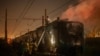 Firefighters put out a fire at a train that was set on fire by suspected paramilitary militia members at Recreio dos Bandeirantes, Rio de Janeiro, Brazil on Oct. 23, 2023.