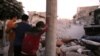 People react following a reported airstrike by Syrian regime forces in the town of Maaret al-Numan in Syria's northwestern Idlib province, Aug. 28, 2019. 
