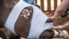 FILE - South African veterinarians apply bandage and stitches to a poached de-horned rhinoceros that was left to die by poachers on a ranch in Bela Bela some 150 KM north of Johannesburg in Bela Bela district, May 20, 2016.