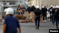 Riot police make their way towards anti-government protesters attempting to stage a rally in Budaiya, west of Manama, Bahrain's capital, May 17, 2013.