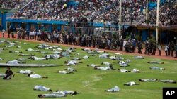 Performers re-enact events at a ceremony to mark the 20th anniversary of the Rwandan genocide, at Amahoro stadium in Kigali, Rwanda, April 7, 2014.