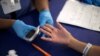 A person receives a test for diabetes during Care Harbor L.A. free medical clinic in Los Angeles, Sept. 11, 2014.