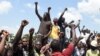 Protesters chant solidarity songs as they block the Lagos-Ibadan expressway, railing against police brutality and the killing of protesters by the military, at Magboro, Ogun state, Nigeria, Oct. 21, 2020. 