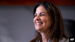 FILE - Kelly Ayotte smiles during a visit to a business in Manchester, New Hampshire, Oct. 16, 2024. Ayotte, who was just elected as New Hampshire's next governor, will be one of 13 female governors in the United States next year.