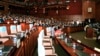 FILE - Prime Minister Hun Sen, front row center, and lawmakers from his ruling Cambodian People's Party sit near empty seats held by opposition lawmakers, inside the session hall of the National Assembly, in Phnom Penh, Cambodia, Tuesday, Sept. 24, 2013. 