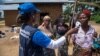 Dr. Marie-Roseline Darnycka Bélizaire, World Health Organization (WHO) Epidemiology Team Lead, talks to women as part of Ebola contact tracing, in Mangina, Democratic Republic of Congo, Aug. 26, 2018.