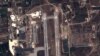FILE - Handout image taken by EADS' Astrium Press by Pleiades Satellite purports to show view of Russian fighter jets and helicopters at a military base in Latakia, Syria, Sept. 20, 2015.