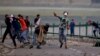 Kashmiri Muslim protesters throw stones at Indian troops in Srinagar, Indian-controlled Kashmir, July 12, 2016. Violence erupted following the Friday killing of rebel commander Burhan Wani.