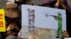 FILE - A North Korean defector reacts next to a drawing depicting a public execution of a North Korean soldier during a human rights rally in Seoul, South Korea, April 14, 2011. 