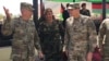 FILE - U.S. Gen. John Nicholson, top U.S. commander in Afghanistan, left, talks with Col. Khanullah Shuja, commander of the Afghan special operations force, and U.S. Gen. Joseph Votel, head of U.S. Central Command, at Camp Morehead in Afghanistan, Aug. 20, 2017.